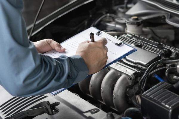 Auto technician conducting vehicle inspection